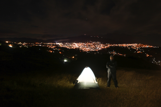 standing in tent overlooking the city lights