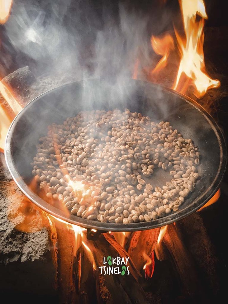 coffee beans in a pan under fire