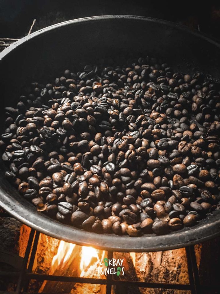 roasted coffee in a pan under fire